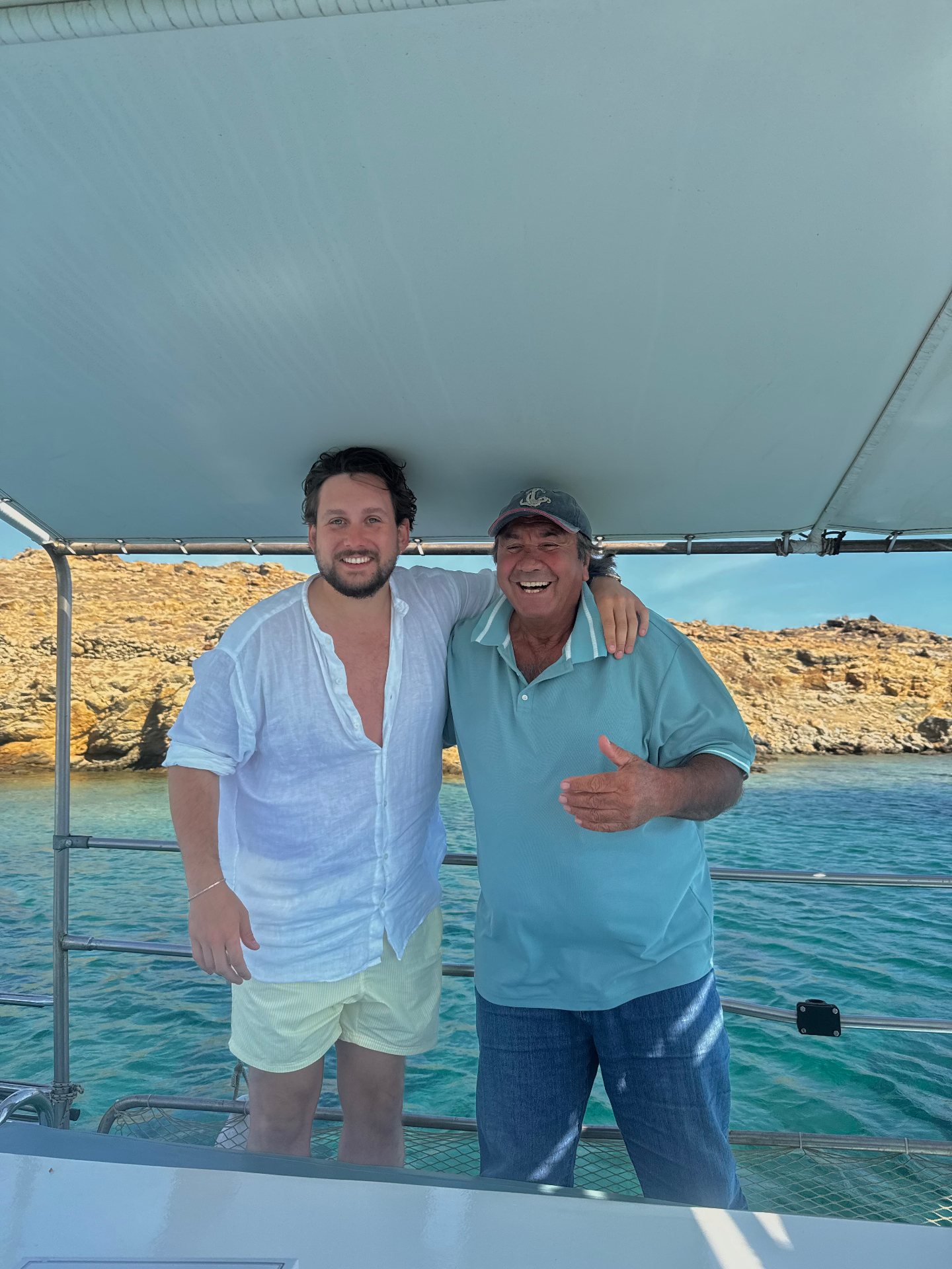Daniel Daly with Captain Sarantis aboard his traditional Greek fishing boat in the Aegean.