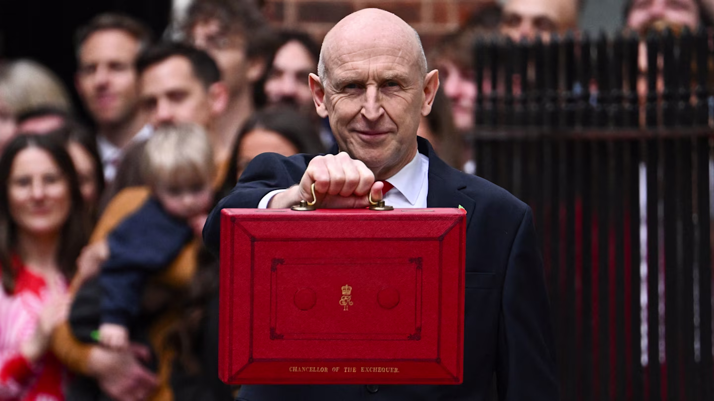 A man holding the red Budget box outside Downing Street.